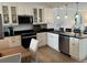 Bright kitchen featuring white cabinets, stainless steel appliances and granite countertops at 18304 Gulf Blvd # 309, Redington Shores, FL 33708