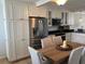 Kitchen and dining area featuring stainless steel appliances and white cabinetry at 18304 Gulf Blvd # 309, Redington Shores, FL 33708