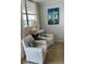 Cozy sitting area with comfortable armchairs and a sailboat painting at 18304 Gulf Blvd # 309, Redington Shores, FL 33708