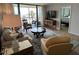 Comfortable living room with a balcony, ocean view, and adjacent bedroom at 18304 Gulf Blvd # 309, Redington Shores, FL 33708