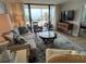 Cozy living room with neutral tones, comfortable seating, and balcony with ocean view at 18304 Gulf Blvd # 309, Redington Shores, FL 33708