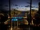 Night view of the illuminated community pool and ocean with palm trees at 18304 Gulf Blvd # 309, Redington Shores, FL 33708