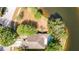 Overhead shot highlighting the property's location, complete with a pool, driveway, mature trees, and proximity to a lake at 19227 Garden Quilt Cir, Lutz, FL 33558