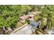 Aerial view of home with lush landscaping and a private driveway, near a serene pond at 19227 Garden Quilt Cir, Lutz, FL 33558