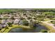 An aerial view showcases houses with a beautiful lake view and verdant trees at 19227 Garden Quilt Cir, Lutz, FL 33558