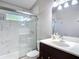 Contemporary bathroom with a glass-enclosed shower, sleek fixtures, and a spacious vanity at 19227 Garden Quilt Cir, Lutz, FL 33558
