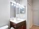 Bathroom featuring single vanity, white countertop, dark wood cabinet, and double mirrors at 19227 Garden Quilt Cir, Lutz, FL 33558