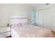 Bedroom featuring bed, bedside tables, closet, and wood floors offers a cozy private space at 19227 Garden Quilt Cir, Lutz, FL 33558