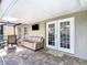 Covered patio featuring brick pavers, outdoor seating, a ceiling fan, and a mounted television at 19227 Garden Quilt Cir, Lutz, FL 33558