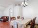 Traditional dining room featuring a dark wood table set, decorative chandelier, and neutral wall paint at 19227 Garden Quilt Cir, Lutz, FL 33558
