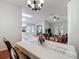 Open dining area showcasing white walls, a decorative chandelier, and an open concept with other living spaces at 19227 Garden Quilt Cir, Lutz, FL 33558
