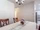 Neutral dining area showcasing decorative chandelier and an open layout that flows to the kitchen at 19227 Garden Quilt Cir, Lutz, FL 33558