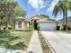 Inviting single-story home with stone accents, a two-car garage, and manicured landscaping at 19227 Garden Quilt Cir, Lutz, FL 33558