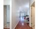 Hallway featuring hardwood floors leading to a bright living room with French doors at 19227 Garden Quilt Cir, Lutz, FL 33558