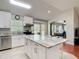 Bright kitchen boasts white cabinets, granite countertops, stainless appliances, and a center island with seating at 19227 Garden Quilt Cir, Lutz, FL 33558