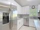 Modern kitchen featuring stainless steel appliances, custom cabinetry, granite countertops, and window lighting at 19227 Garden Quilt Cir, Lutz, FL 33558
