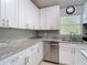 Modern kitchen showcasing granite countertops, stainless steel appliances, and ample cabinetry at 19227 Garden Quilt Cir, Lutz, FL 33558