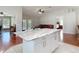 Bright kitchen featuring a central island with a granite countertop and white cabinets, perfect for entertaining at 19227 Garden Quilt Cir, Lutz, FL 33558