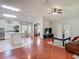 Open-concept living room features hardwood floors, stainless steel appliances, and a spacious island with seating at 19227 Garden Quilt Cir, Lutz, FL 33558