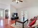 This living room has hardwood floors, vaulted ceilings, and French doors leading to the backyard at 19227 Garden Quilt Cir, Lutz, FL 33558