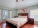 Spacious main bedroom with wood floors, bay windows, and natural light at 19227 Garden Quilt Cir, Lutz, FL 33558