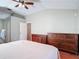 Bright main bedroom with wooden floors, ceiling fan, and ensuite bathroom featuring a convenient door to the bedroom at 19227 Garden Quilt Cir, Lutz, FL 33558