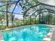 Inviting screened-in pool offers a serene backyard view, perfect for relaxation and enjoying the outdoors at 19227 Garden Quilt Cir, Lutz, FL 33558