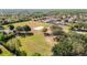 Aerial photograph of neighborhood recreation areas featuring a field, tennis and volleyball courts, and a playground at 19227 Garden Quilt Cir, Lutz, FL 33558
