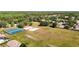 Enjoy neighborhood amenities: an aerial view of tennis and volleyball courts, playground, and recreation field at 19227 Garden Quilt Cir, Lutz, FL 33558
