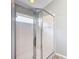 Shower featuring a glass enclosure, a shower head, and white tiled walls at 19227 Garden Quilt Cir, Lutz, FL 33558