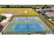 Aerial view of tennis courts surrounded by fencing and landscaping at 19227 Garden Quilt Cir, Lutz, FL 33558