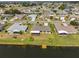 An aerial view of waterfront homes with well-manicured lawns and a private dock at 2003 Wedge Ct, Sun City Center, FL 33573