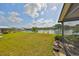 Expansive backyard with lush green lawn, a serene lake view, and a private dock at 2003 Wedge Ct, Sun City Center, FL 33573