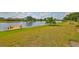 Waterfront backyard featuring a dock and lush landscaping at 2003 Wedge Ct, Sun City Center, FL 33573