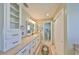 Bathroom featuring white cabinets, granite countertops, a tile floor, and walk-in closet at 2003 Wedge Ct, Sun City Center, FL 33573