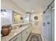 Elegant bathroom featuring granite counters, modern fixtures, and a glass-enclosed shower at 2003 Wedge Ct, Sun City Center, FL 33573