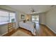 Well-lit bedroom with hardwood floors, a ceiling fan, and a sliding glass door to a patio at 2003 Wedge Ct, Sun City Center, FL 33573