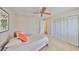 Bright bedroom with a ceiling fan, large closet and comfortable bed with decorative pillows at 2003 Wedge Ct, Sun City Center, FL 33573