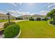 Charming single-story home with a lush green lawn and mature landscaping at 2003 Wedge Ct, Sun City Center, FL 33573