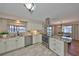 Well-lit kitchen with stainless steel appliances, granite countertops, and seamless flow into the dining area at 2003 Wedge Ct, Sun City Center, FL 33573
