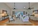 Open living room featuring vaulted ceiling, ceiling fan and wood flooring at 2003 Wedge Ct, Sun City Center, FL 33573