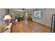 Spacious living room showcasing hardwood floors, natural light, and a view into the dining area and kitchen at 2003 Wedge Ct, Sun City Center, FL 33573