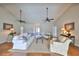 Living room featuring a neutral color scheme, vaulted ceilings, ceiling fans, and hardwood flooring at 2003 Wedge Ct, Sun City Center, FL 33573