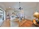 Bright living room with vaulted ceiling and ceiling fans features hardwood floors and access to patio at 2003 Wedge Ct, Sun City Center, FL 33573