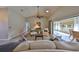 Open living room leading to sunroom with water views at 2003 Wedge Ct, Sun City Center, FL 33573