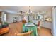 Cozy living room and kitchen combination with hardwood floors and a chandelier lit dining area at 2003 Wedge Ct, Sun City Center, FL 33573