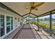 Inviting screened patio overlooking a lake, equipped with a ceiling fan and offering a tranquil outdoor space at 2003 Wedge Ct, Sun City Center, FL 33573