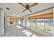 Bright sunroom with tile flooring, ceiling fan and multiple windows at 2003 Wedge Ct, Sun City Center, FL 33573