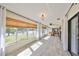 Large sunroom with tile flooring and multiple windows with water views at 2003 Wedge Ct, Sun City Center, FL 33573