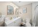 Bright bathroom featuring double sinks, modern fixtures, and a walk-in shower at 2250 64Th N St, St Petersburg, FL 33710